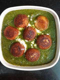 A picture of Shahi Paneer Koftas in Palak gravy.