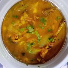 A picture of Chicken curry with potato and moong dal in Assamese style.