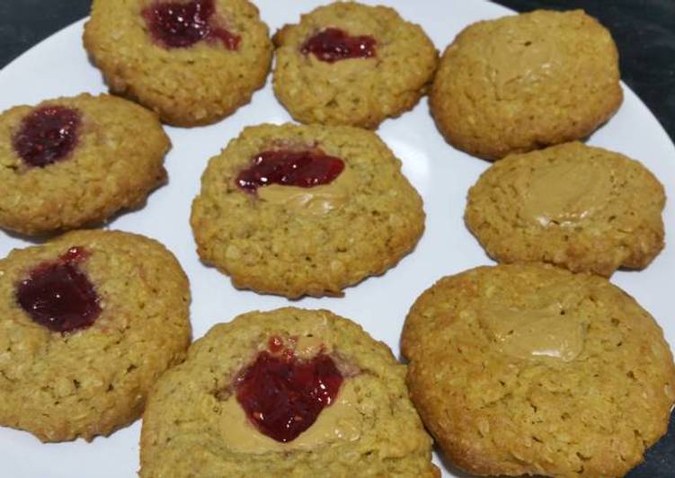 Easy oat cookies with raspberry jam and peanut butter filling