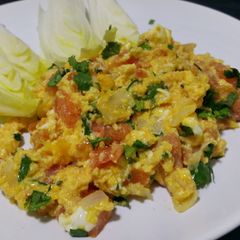 A picture of Herby cheese, egg and tomato scramble.