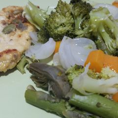 A picture of Grilled chicken breast with steamed vegetables.