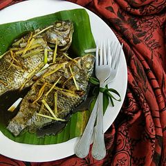 A picture of Steamed Fish in banana leaf.