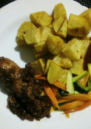 A picture of Diced potatoes, buttered vegetables and barbeque chicken.