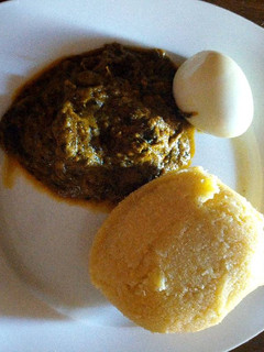 A picture of Banga soup with boiled egg and Eba.