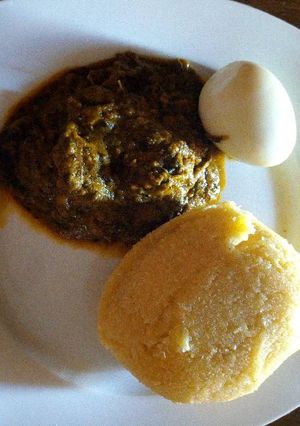 A picture of Banga soup with boiled egg and Eba.