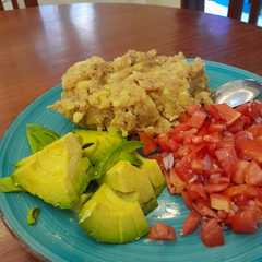 A picture of Mashed Matoke with Avocado and Tomato Salad.