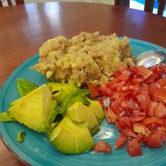 A picture of Mashed Matoke with Avocado and Tomato Salad.