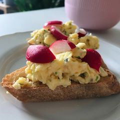 A picture of Scrambled eggs with chives on sourdough.