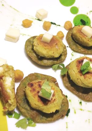 A picture of Palak bytes with cheese falafal.