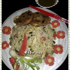 A picture of Chicken fried rice with shami kabab.