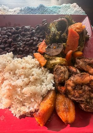 A picture of Jerk Shrimp with Coconut Rice and Baked Veggies.