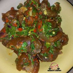 A picture of Kpomo pepper sauce with spinach.