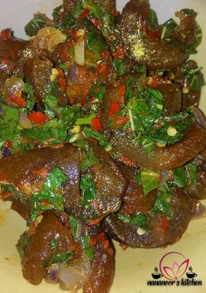 A picture of Kpomo pepper sauce with spinach.