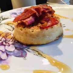 A picture of Maple syrup and bacon on crumpets.