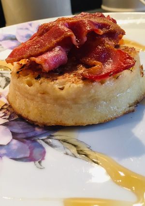 A picture of Maple syrup and bacon on crumpets.
