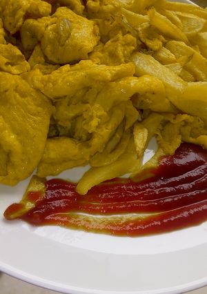A picture of Fried chips and eggs.