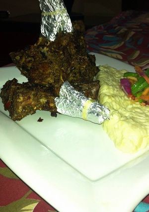 A picture of Fried champ with mashed potatoes and vages.