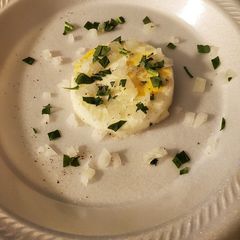 A picture of Poached eggs with cut spinach and onions.