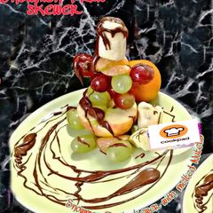 A picture of Snowman fruit skewer with melted nutella.