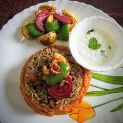Spinach veg pulavo with tomato gravy A picture of Spinach veg pulavo with tomato gravy.