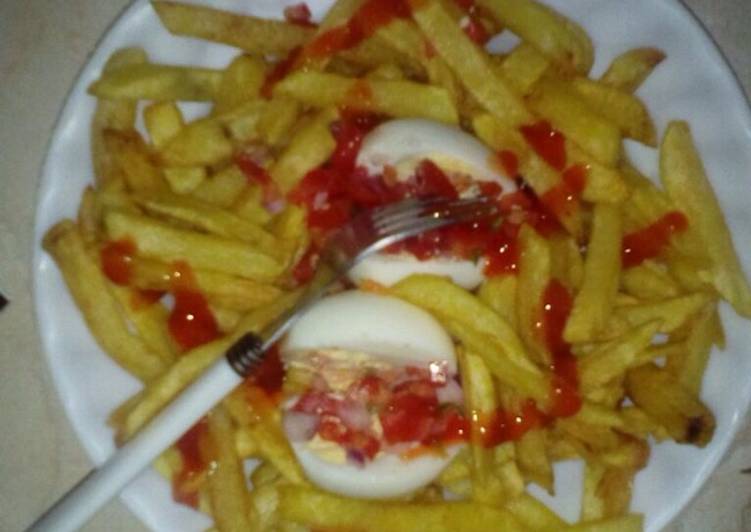 Boiled eggs served with fries