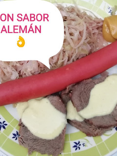 Una foto de Carne y salchichas ahumadas con chucrut y salsa de mostaza