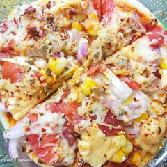 A picture of Pizza loaded with cheeze.