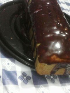 Una foto de Budín de banana y coco con salsa de chocolate y miel
