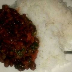 A picture of Bolied rice served with beans.