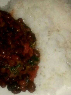 A picture of Bolied rice served with beans.