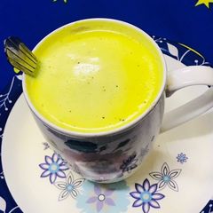 A picture of Golden milk with dash of honey.