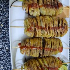 A picture of Red spicy Potato 🥔 spiral sticks.