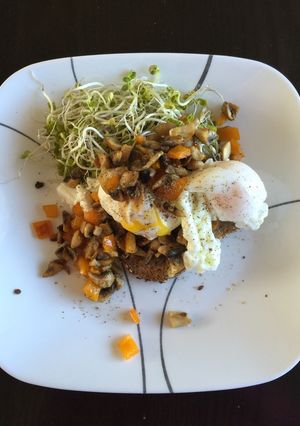 A picture of Poached eggs with veggies and shoots.