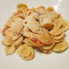A picture of Fresh pasta with tomato and pecorino.