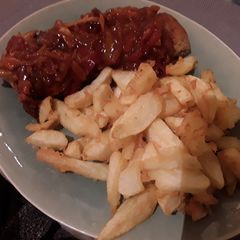 A picture of Sig's Porkloin Steak with Pepper & Onion Sauce.