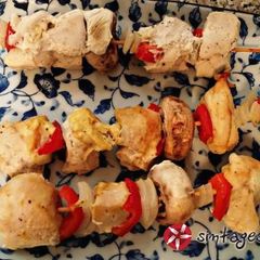 A picture of Marinated chicken souvlaki in the oven.