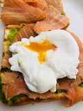Poached egg on avocado mashed and smoke salmon on toast