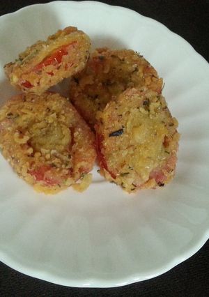 Una foto de Tomate empanizado con ajo y orégano