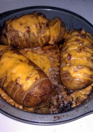A picture of Loaded Fan Baked Potatoes.