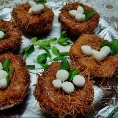 A picture of Birds nest made up from potatoes and cheese.