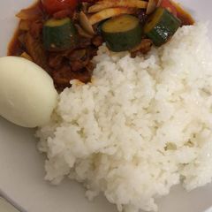 A picture of White rice and veggie sauce.