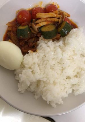 A picture of White rice and veggie sauce.