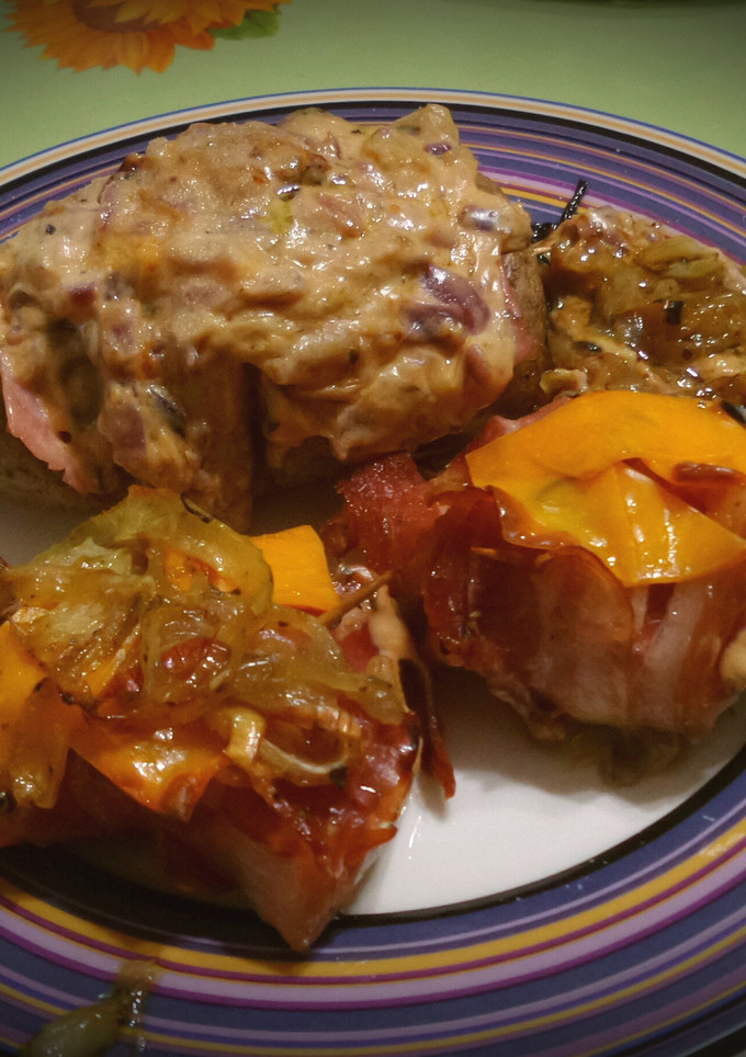 Una foto de Pechugas envueltas acompañadas de papas rellenas