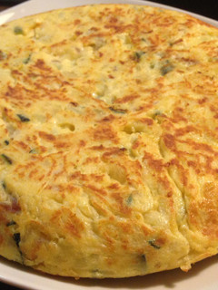 Una foto de Tortilla de patata, calabacín y cebolla roja