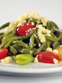 Una foto de Ensalada de nopales, habas y tomates con queso fresco.