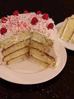 A picture of Vanilla Lemon Raspberry Layer Cake with Whipped Cream Buttercream Frosting.