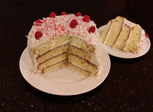 A picture of Vanilla Lemon Raspberry Layer Cake with Whipped Cream Buttercream Frosting.