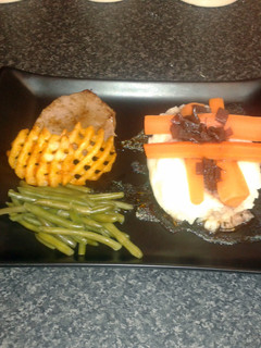 A picture of steak medallion with red wine reduction, crispy slice, butter mash & veg.