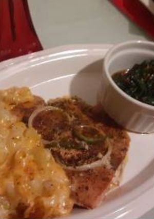 A picture of Baked salmon macin cheese. Spicy pepper flake SPINACH.