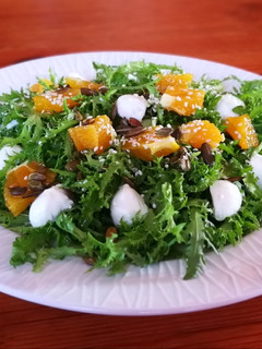 Una foto de Escarola con naranja, semillas y mozzarella